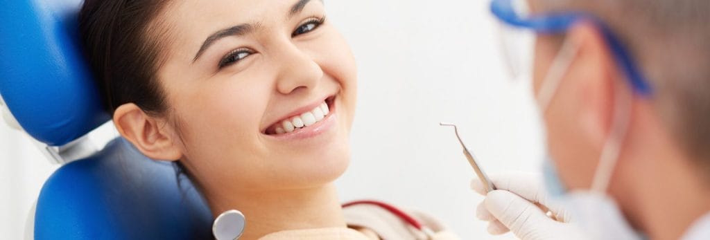 Happy lady siting on a dental chair